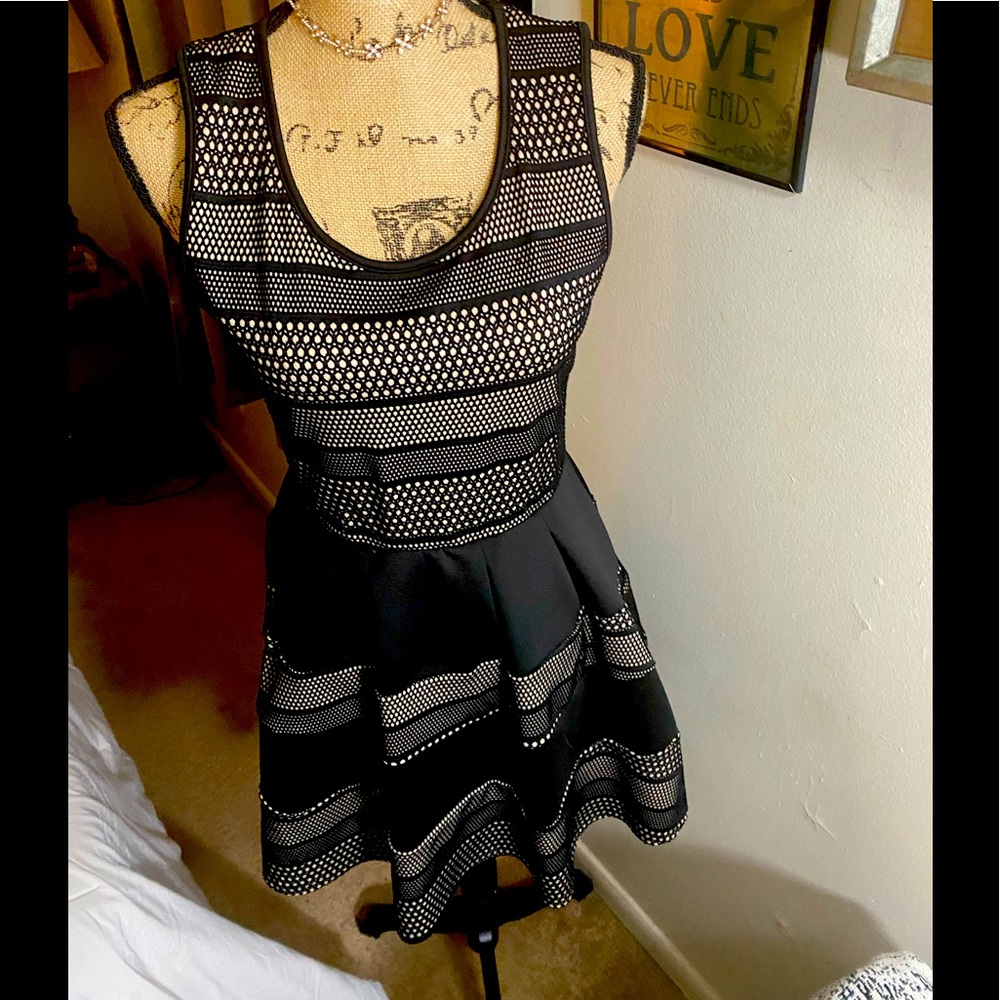 Black dress with nude underlay.